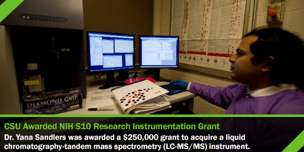 Research student using a liquid chromatography-tandem mass spectrometry (LC-MS/MS) instrument