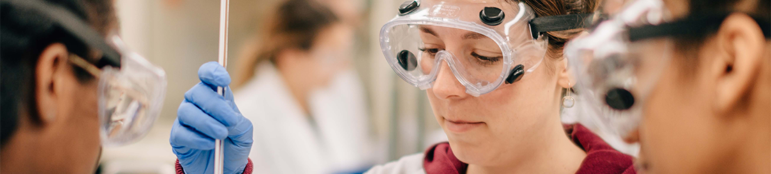 Three students working on research in a lab.