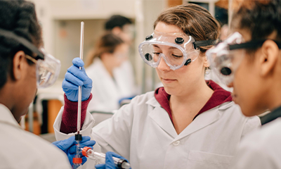 Three students working on research in a lab.