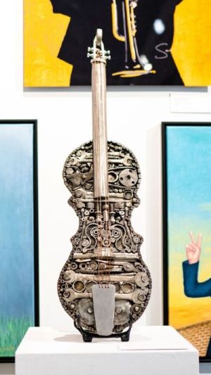 metal violin created from donated automotive parts