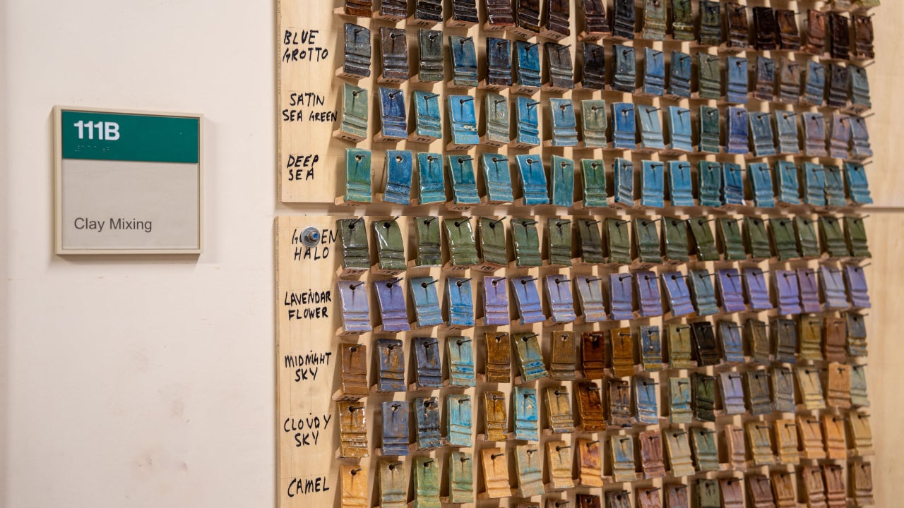 Glaze swatches hung in CSU's ceramics studio with a sign that reads "clay mixing".