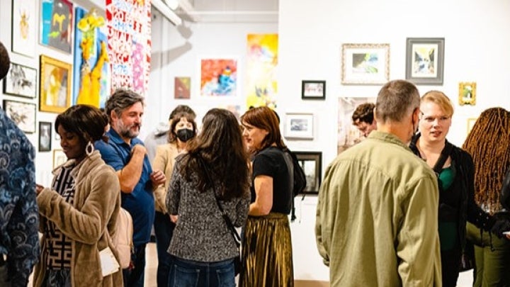 Group of Individuals Viewing CSU Student Art