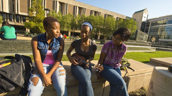 Three females sitting and enjoying the CSU courtyard