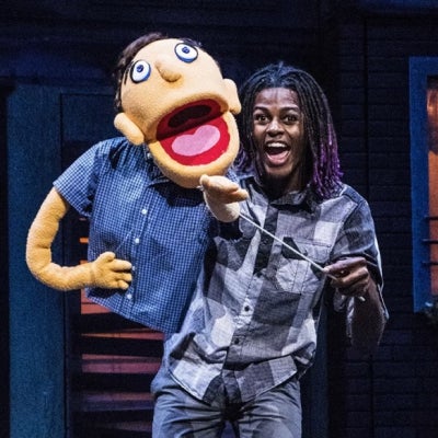 an actor with a puppet performing