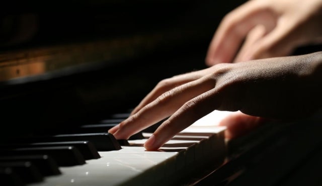 Hands playing piano