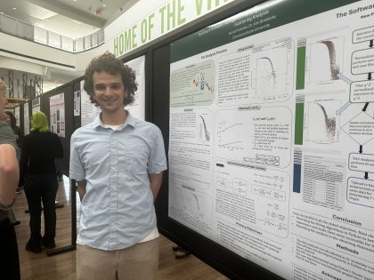 Physics student Jacob Forester at a poster session