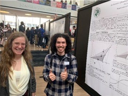 Two students pictured at a research poster session