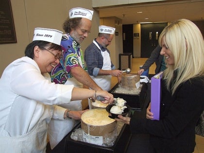 Dr. Lily Ng serving ice cream to a student
