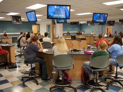 A group of students listening to a lecture in a classroom.