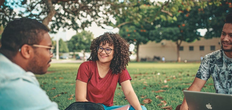 students sitting outside